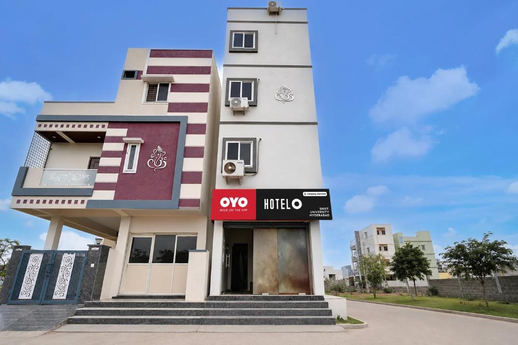 a white building with a sign in front of it at Hotel O SNIST University Hyderabad Formerly Hari Hara Enterprise in Maula Ali