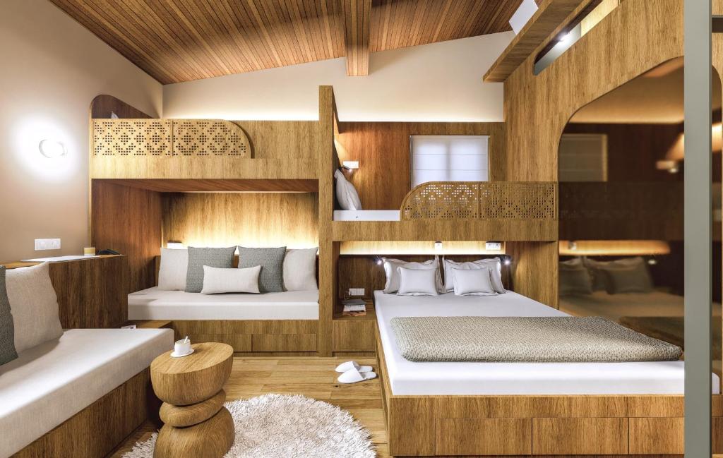 a room with two beds and a bunk bed at Olympus Refuge D in Litochoro