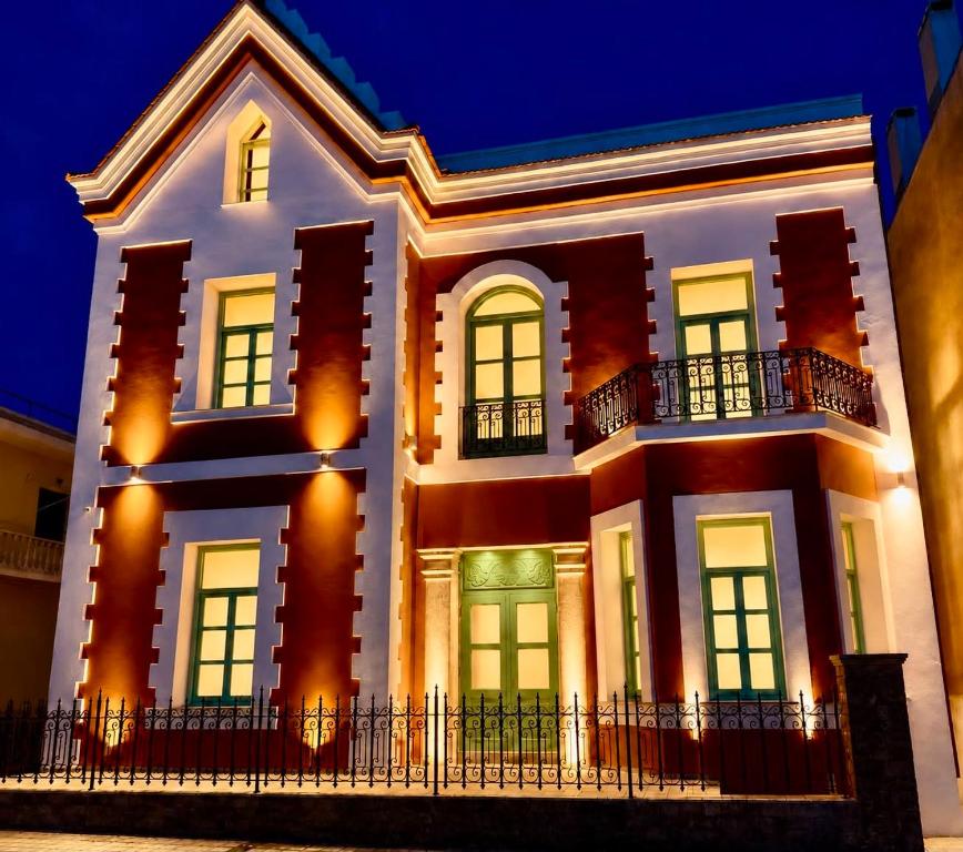 a large white house with lights on at Neossiko Chios in Chios