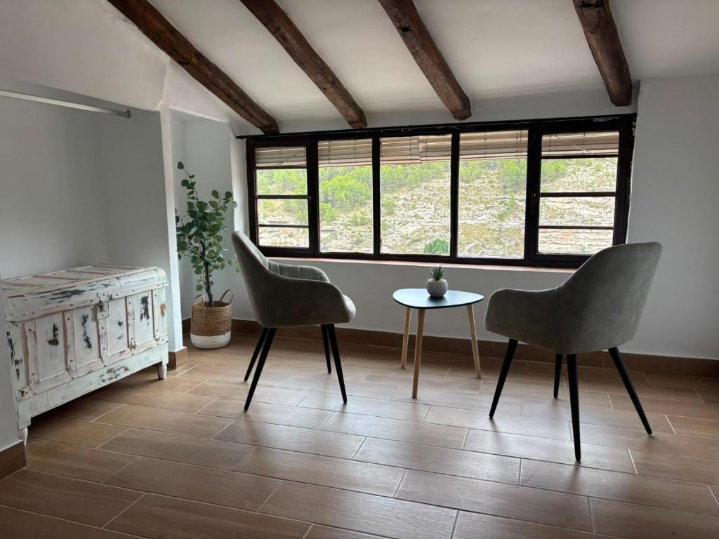 a living room with two chairs and a table at Origen&Madera in Alcalá del Júcar