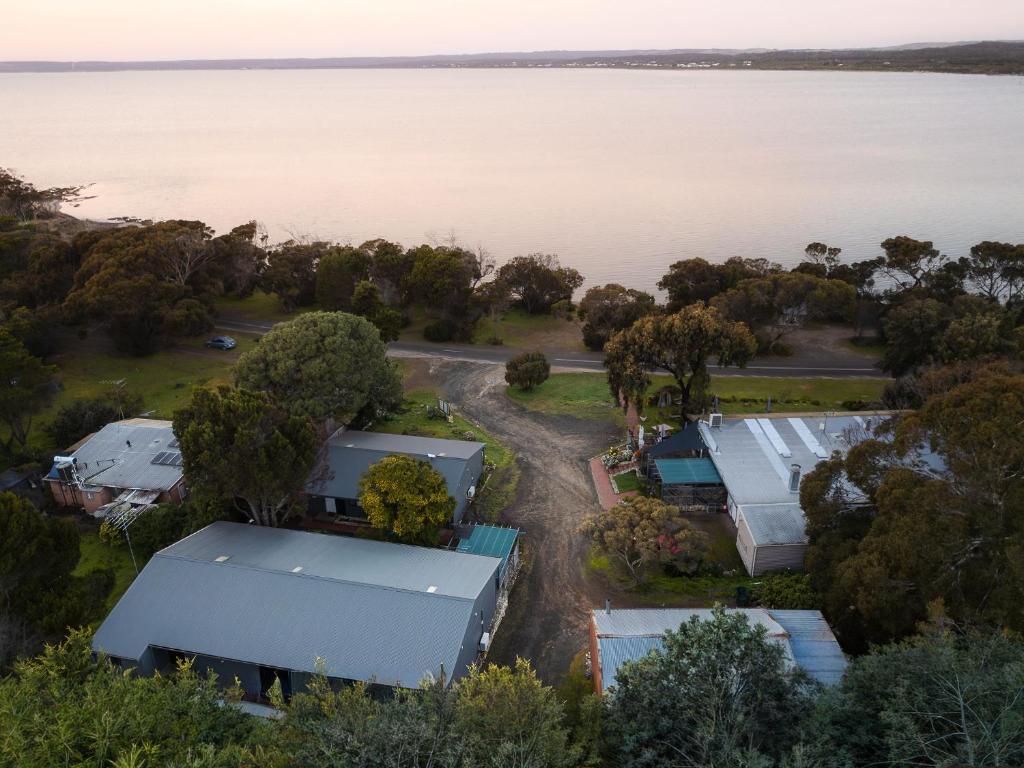 an aerial view of a group of buildings next to the water at Bayview Cabins Kangaroo Island in American River