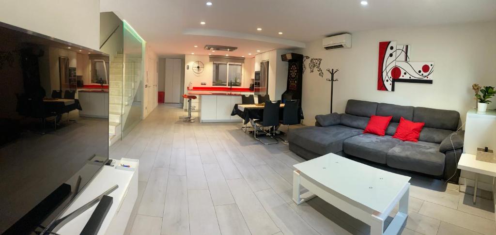 a living room with a couch and a table at Entire 250m2 chalet in Puzol