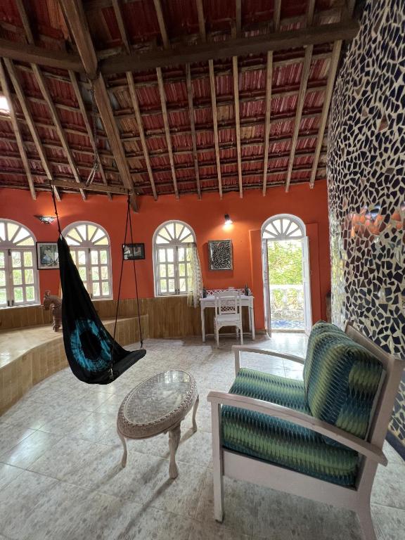 a living room with a hammock in a room at Villa Rivercat in Mandrem