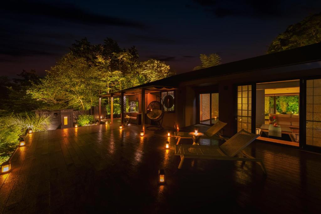 a house with a deck at night with lights at Hakone Kairai in Hakone
