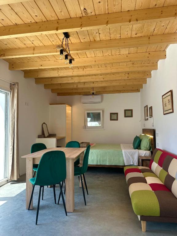 a room with a bed and a table and chairs at Olive Haven in Provatas
