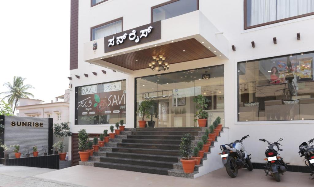 a store front with motorcycles parked outside of it at Hotel Sunrise Luxury Stays in Chikmagalūr