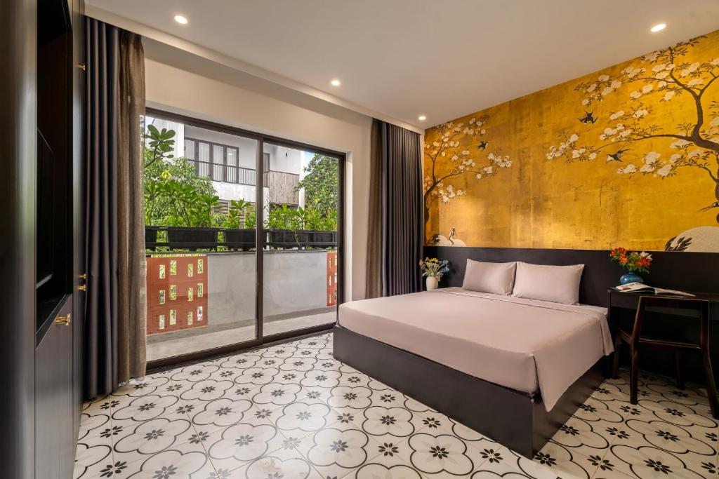a bedroom with a bed and a large window at An Hiên Home in Danang