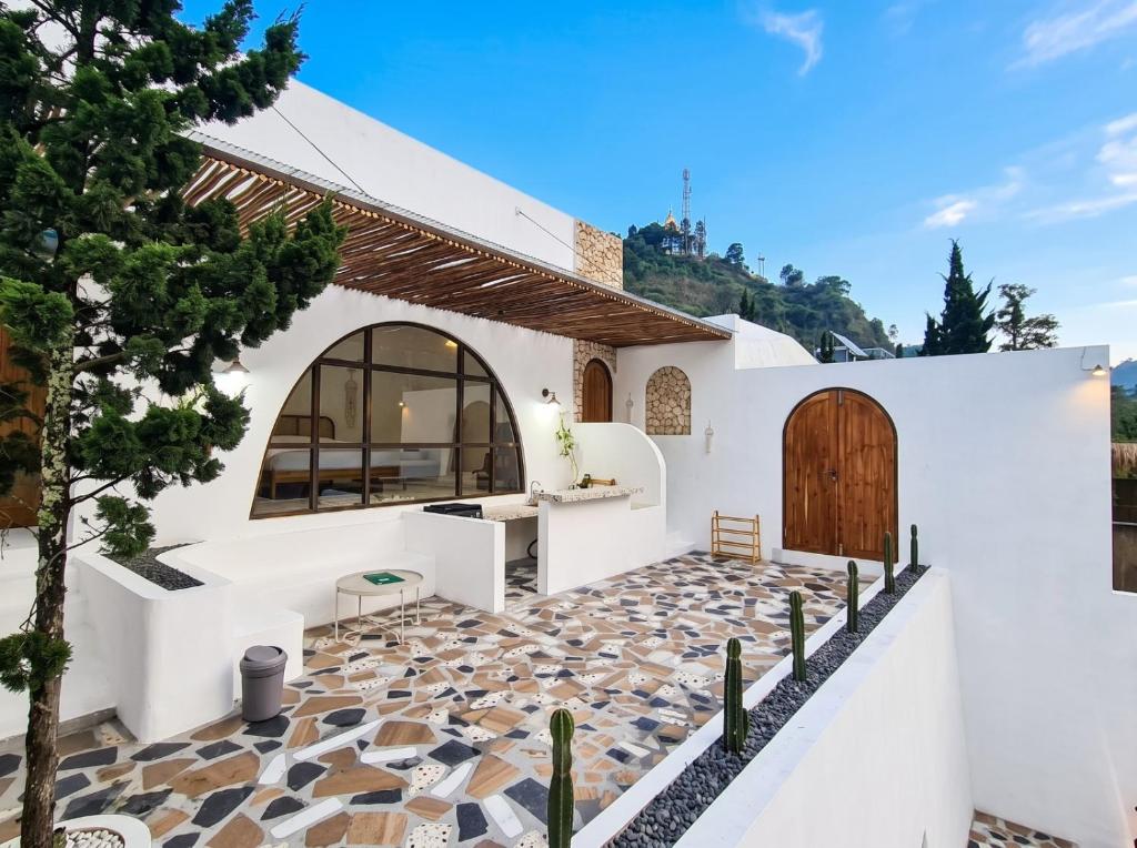 a house with white walls and a patio with cactus at Hanara Bohemian Villa in Bandung