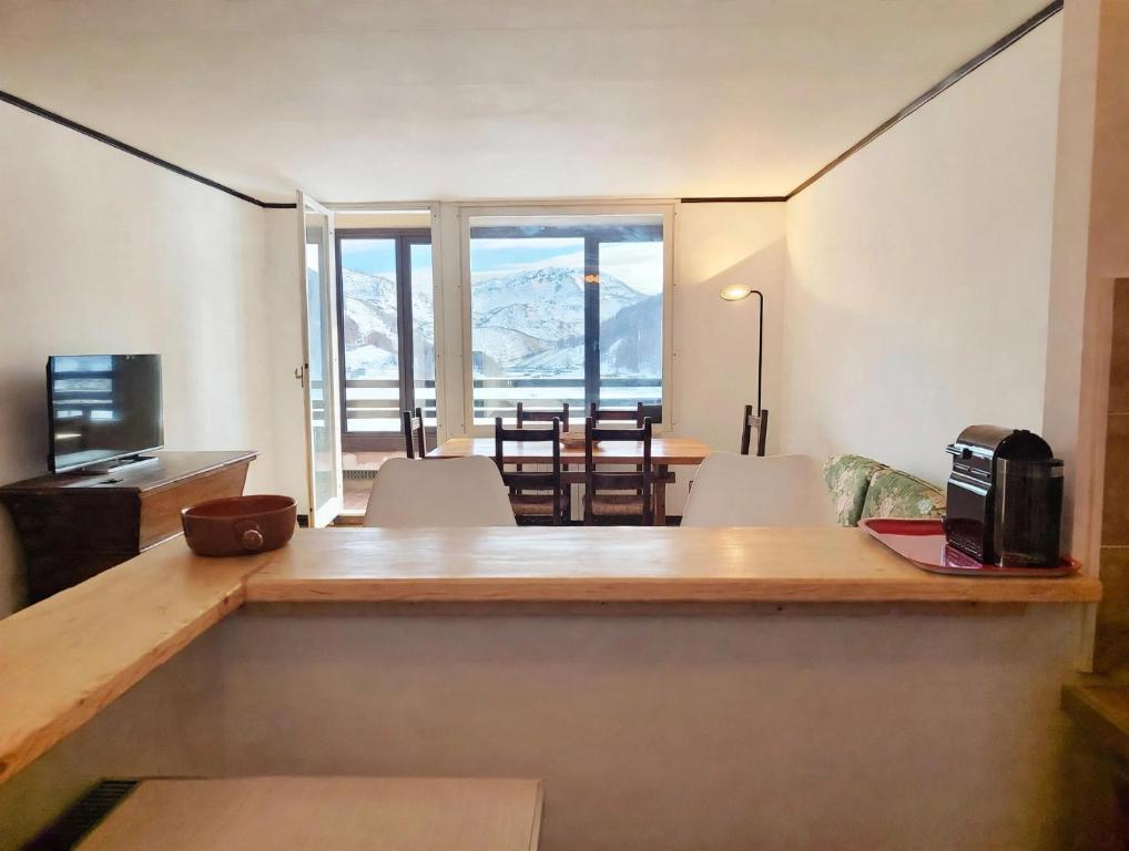 a room with a table and chairs with a view at We ski Matese in San Massimo