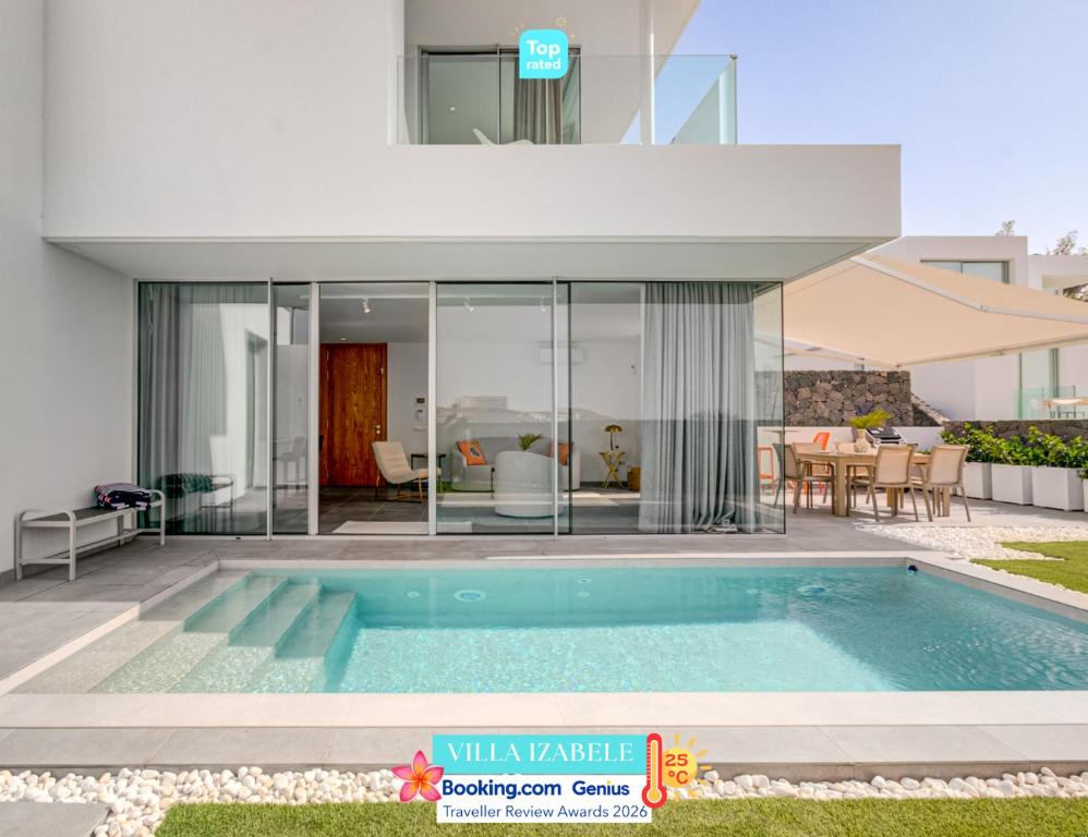 a villa with a swimming pool and a house at Villa Izabele - private heated pool with amazing terrace in Callao Salvaje