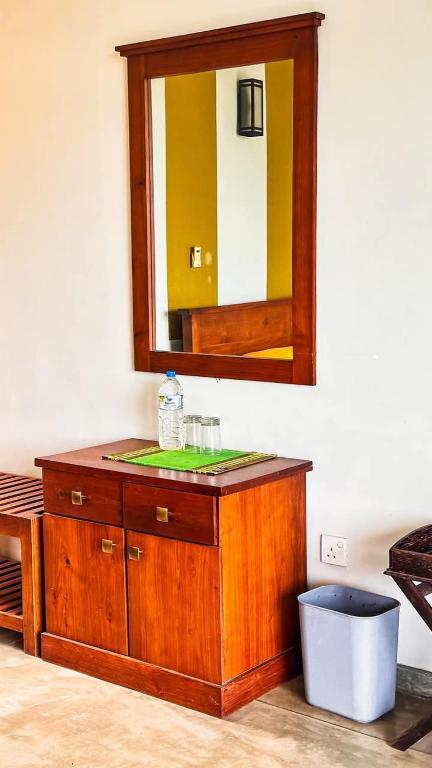 a bathroom with a wooden vanity with a mirror at Lotus villa lake resort in Matara