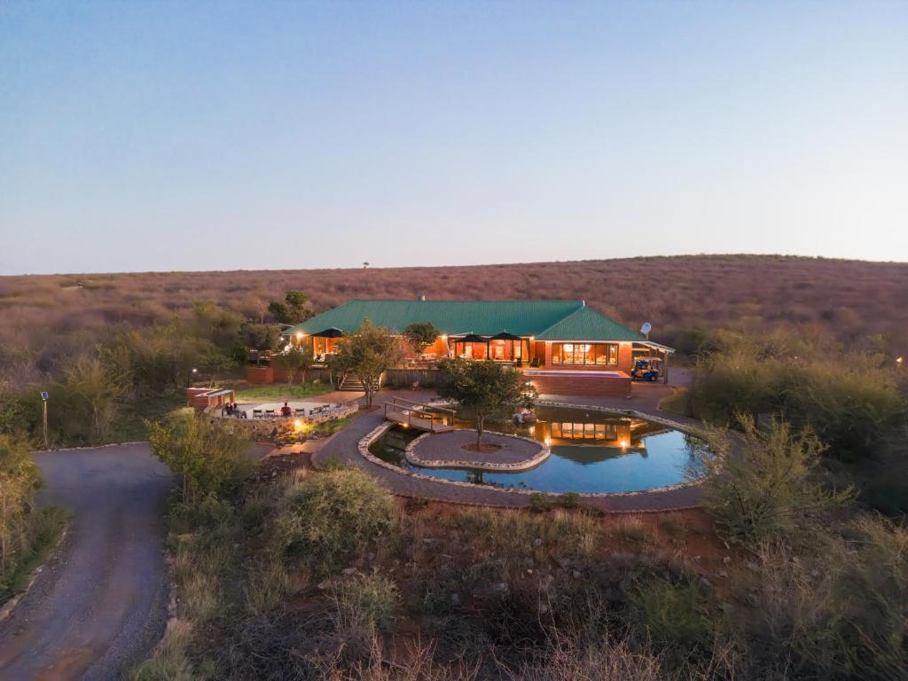 an aerial view of a house in the middle of a field at Rockfig Lodge Madikwe in Madikwe Game Reserve