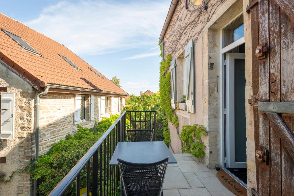a balcony with a table and chairs on a building at "la suite" in Talant