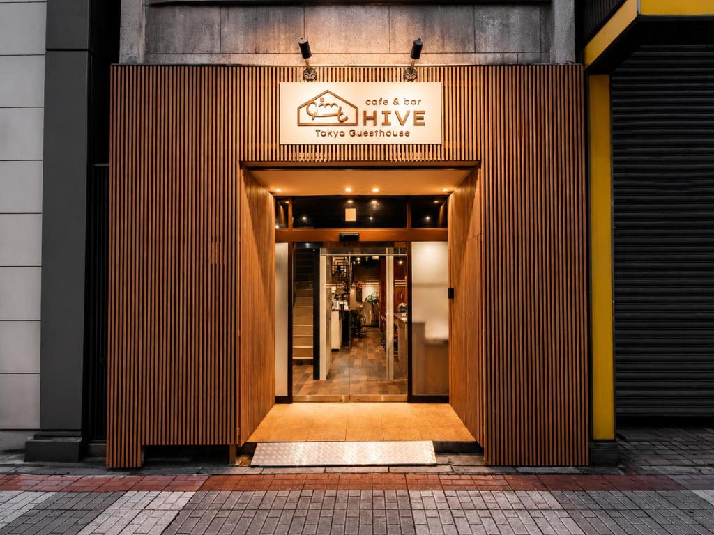 an entrance to a building with a sign on it at Tokyo Guesthouse HIVE in Tokyo