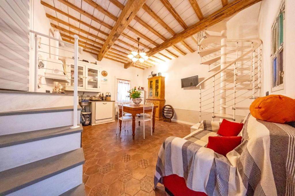 a room with a bed and a kitchen with a table at Loft Elegante nel centro di Dozza, città d'Arte in Dozza