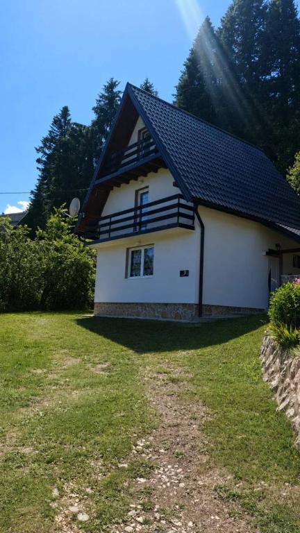 a white house with a black roof at Vikendica Luka in Han Pijesak