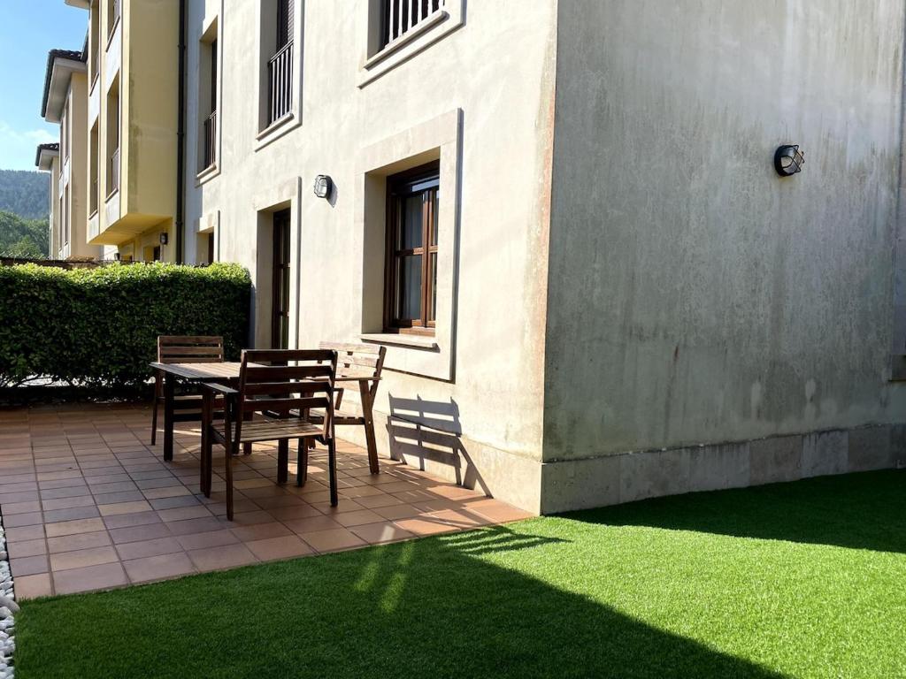 a patio with a table and chairs next to a building at R2R - El Rincón de Luiña - 310A in Soto de Luiña