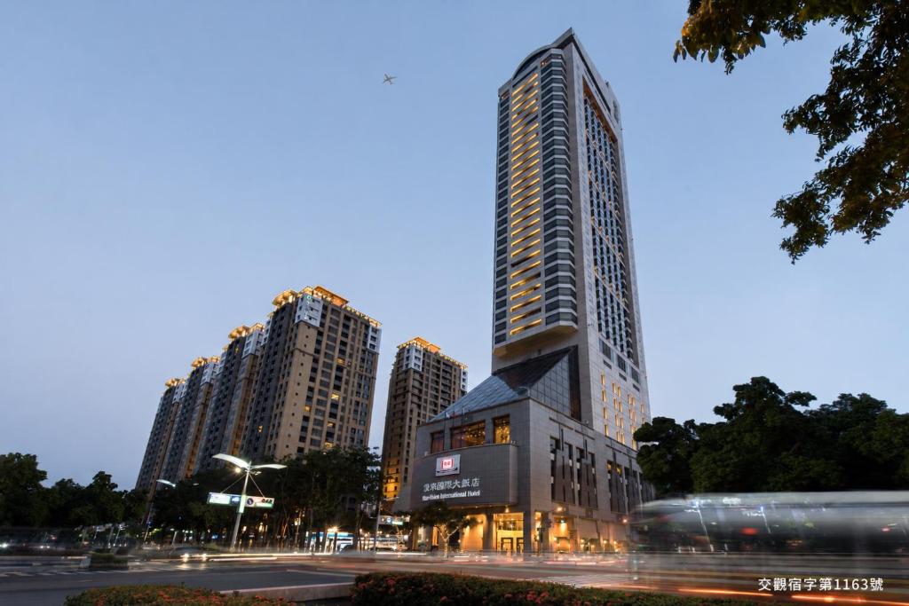 a tall building in a city at night at Han Hsien International Hotel in Kaohsiung