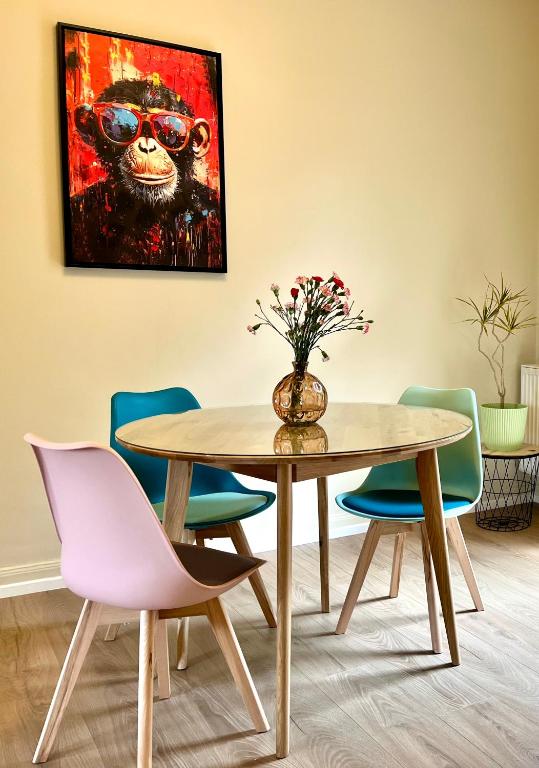 a dining room with a table and a painting of a monkey at Apartments am Burgberg in Bad Harzburg