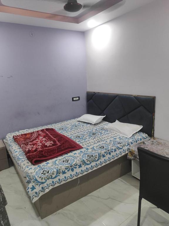 a small bedroom with a bed with a quilt on it at SHRI VIJAYVEER PALACE in Ujjain