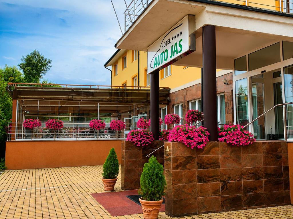 a store with potted plants and flowers in front of it at Hotel Auto Jas in Nitra