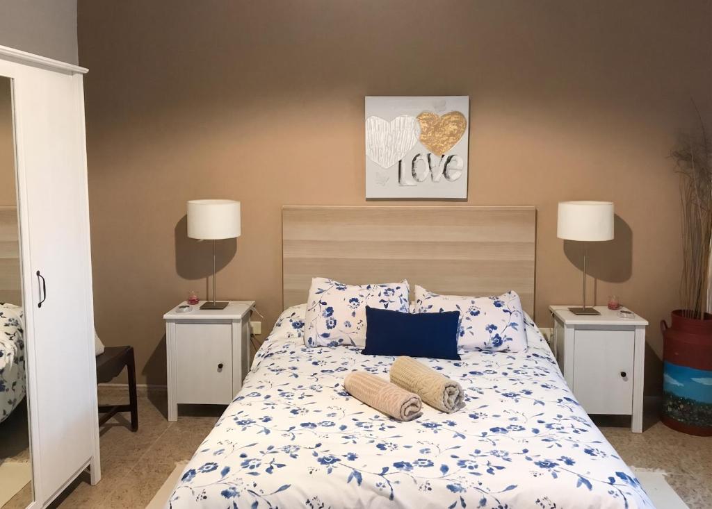 a bedroom with a bed with two night stands at Charming house in Teror with garden in Teror