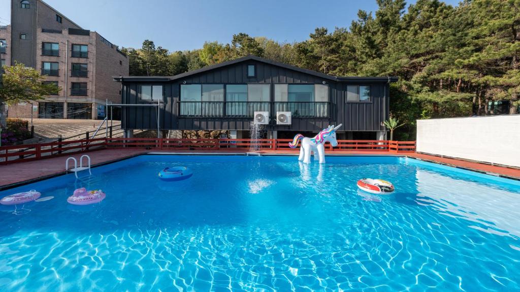 a woman is playing in a swimming pool at Yeongheungdo J Pension in Incheon