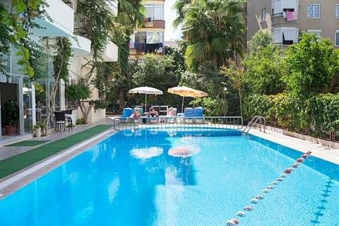 a large blue swimming pool with chairs and umbrellas at THE S APART & SUITES hOTEL in Alanya