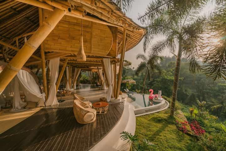 a resort with a building with a porch and a resort at Bamboo Villa with Amazing mount agung view in Selat