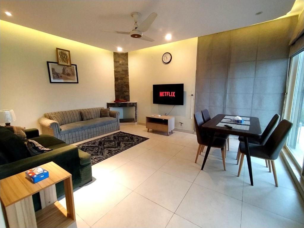 a living room with a couch and a table at Luxe Villa in Murree