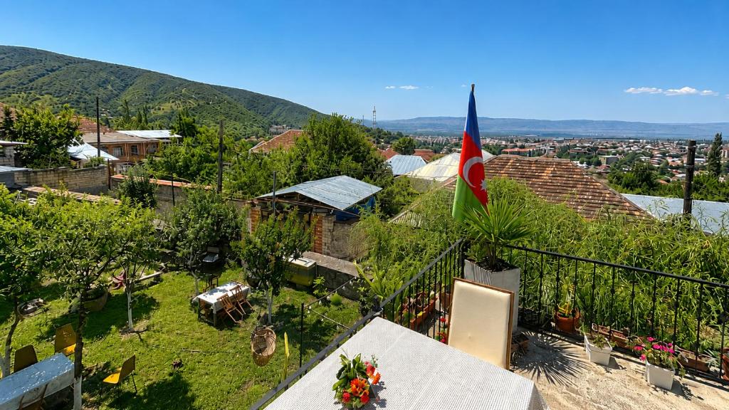 a balcony with a flag on top of a house at Sheki Panorama Garden in Sheki