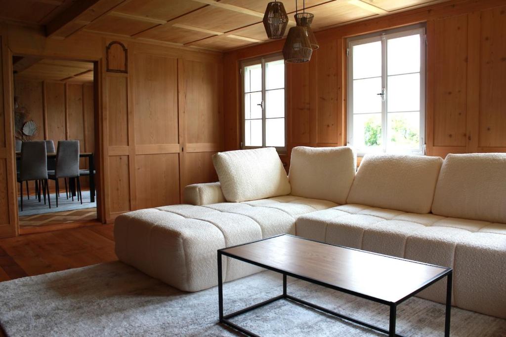 a living room with a couch and a coffee table at BergZeit- Relax Explore Belong in Stalden