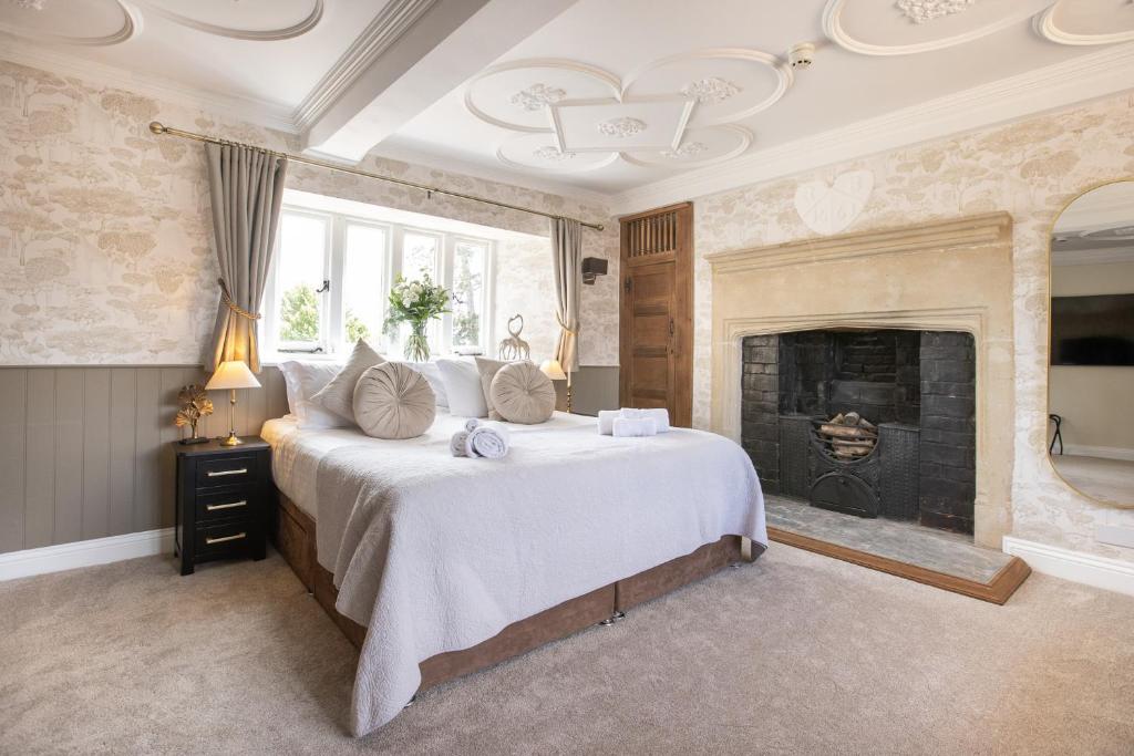 a bedroom with a large bed and a fireplace at The Lighthouse Bed & Breakfast in Frome