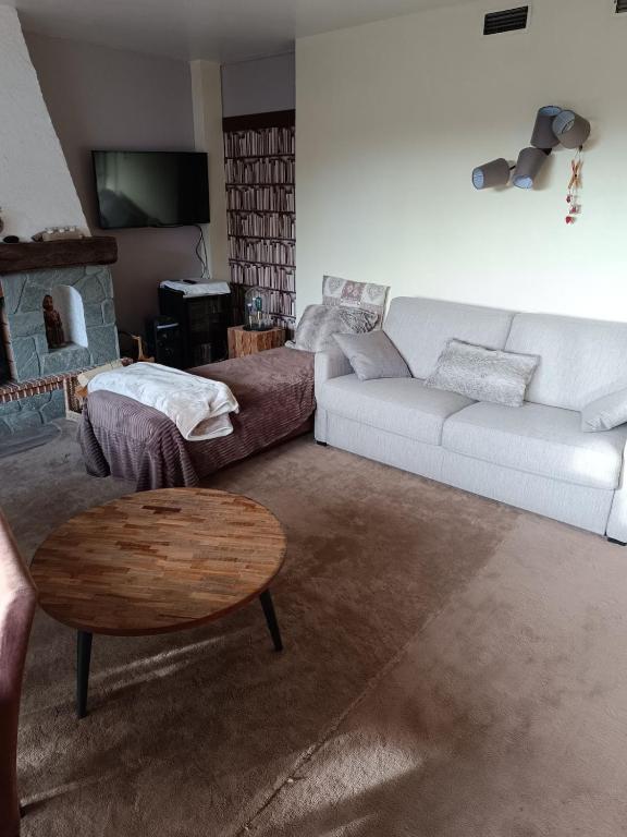 a living room with a couch and a coffee table at Bel Appartement panoramique in Arâches-la-Frasse