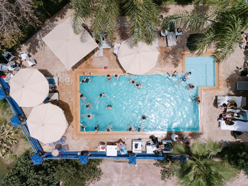an overhead view of a swimming pool with umbrellas at Rive Du Lac in Lalla Takerkoust
