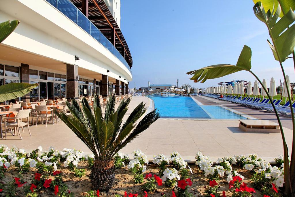 a resort with a swimming pool and flowers at Kahya Resort Aqua & Spa in Konaklı