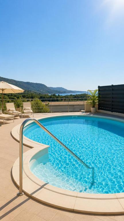 a large swimming pool with a metal rail around it at Glory Guest House Sea View in Mandaradoni