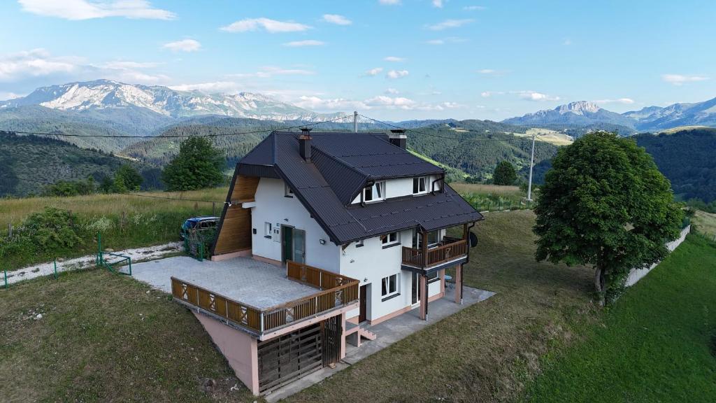 an overhead view of a house with mountains in the background at Utopia Mountain resort Bjelasnica in Bjelašnica