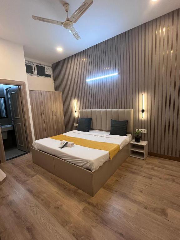 a bedroom with a large bed with a ceiling at Hotel PRM Sweet Stay in Bhundsi