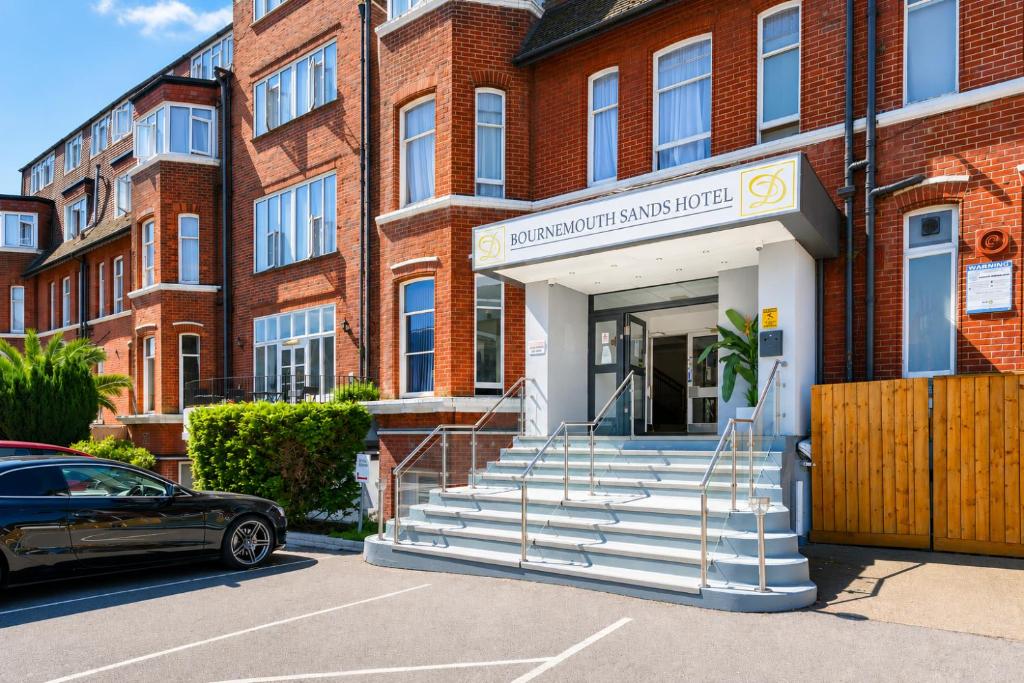 a building with stairs in front of a building at Bournemouth Sands Hotel in Bournemouth