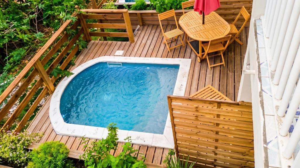 an overhead view of a swimming pool on a wooden deck at Maison charmante Le Moule + piscine in Le Moule