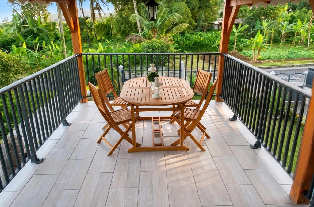 a patio with a table and chairs on a deck at Studio cosy à Capesterre-Belle-Eau avec terrasse in Capesterre-Belle-Eau