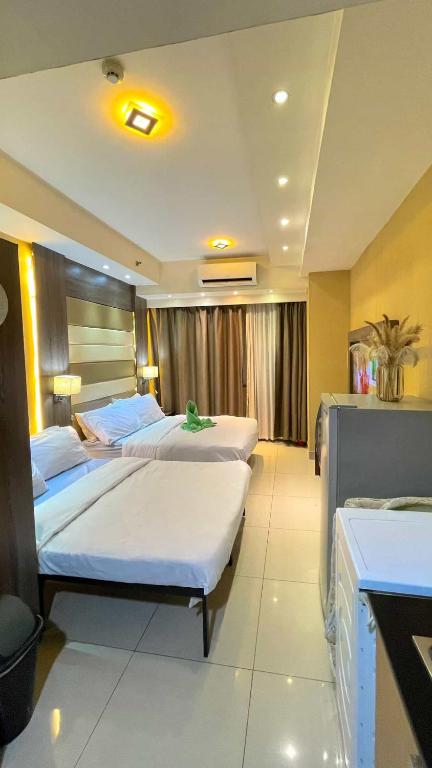 a hotel room with two beds in a room at Shell Residences Tower A B in Manila