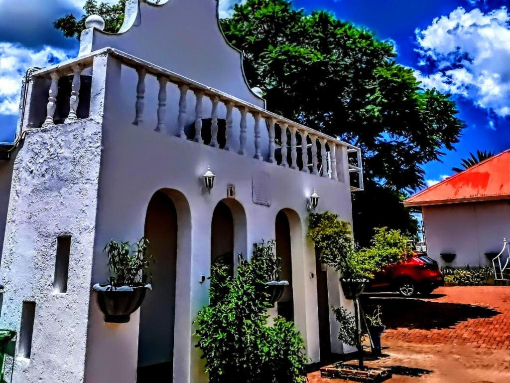 a white building with a red roof at Rosahoff Guesthouse in Windhoek