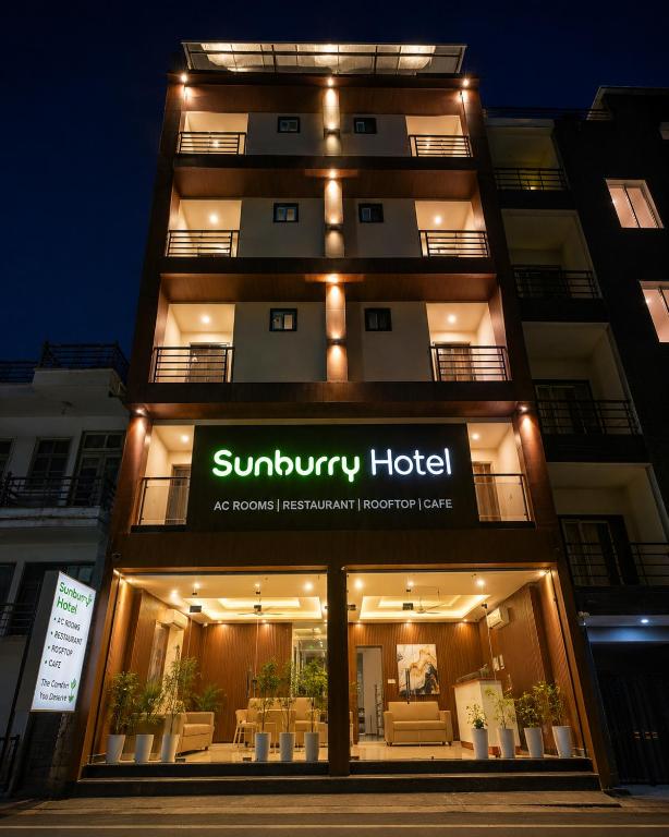 a building with a sign for a hotel at Sunburry Hotel Tapovan Rishikesh in Narendranagar