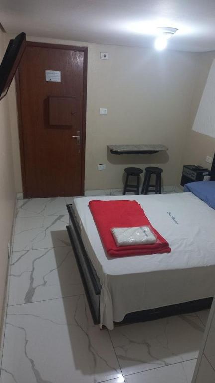 a bedroom with a bed with a red towel on it at Dekatana Hotel Village in Helunmahara