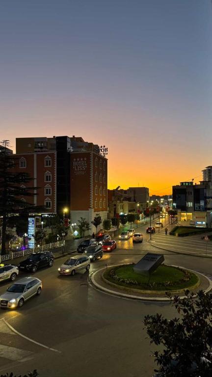 a city with cars parked in a parking lot at Bella Vista Apartment in Lezhë