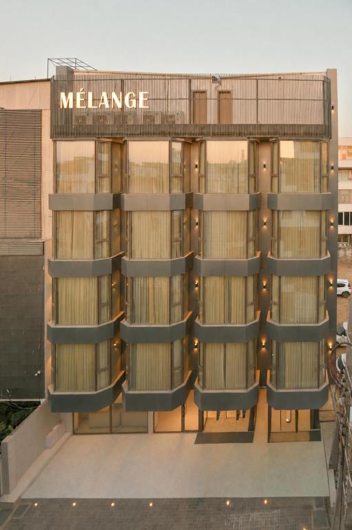 a building with a sign that reads welfare at Melange Hotel - Golf course road in Gurgaon