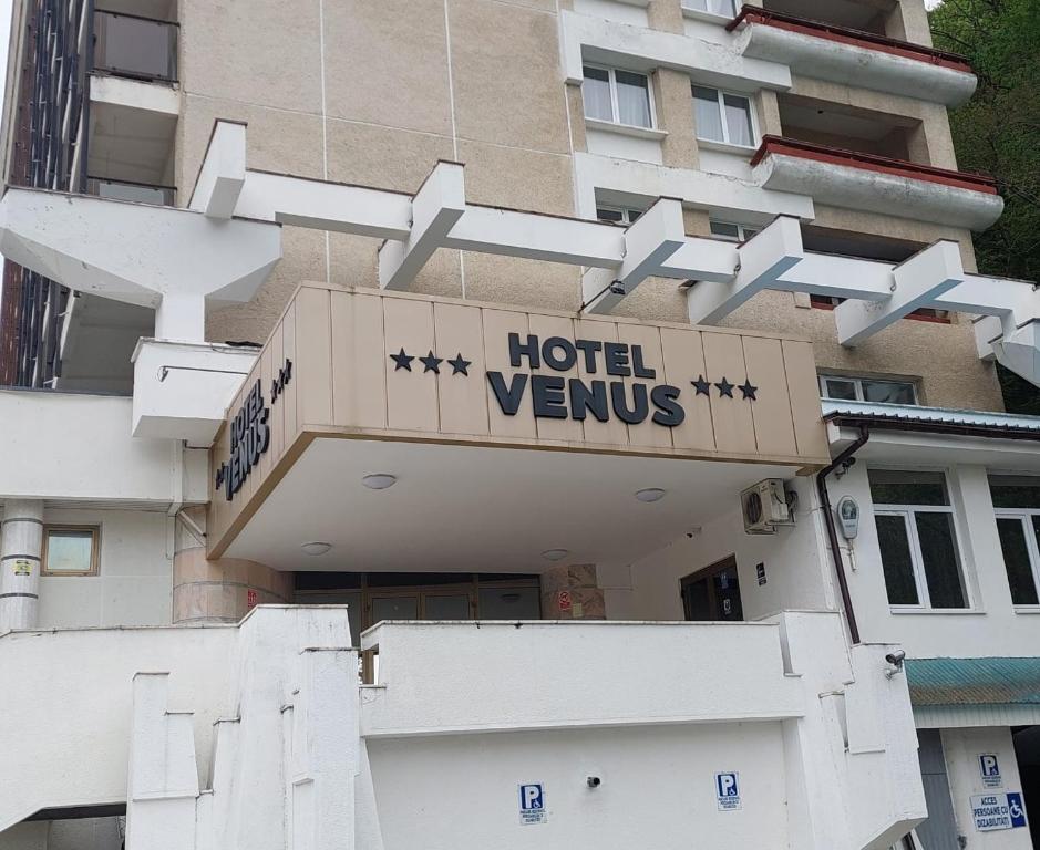 a hotel sign on the side of a building at Hotel Venus in Slănic-Moldova