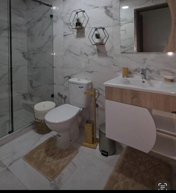 a bathroom with a toilet and a sink and a shower at Nakhla2 in Dar Bouazza